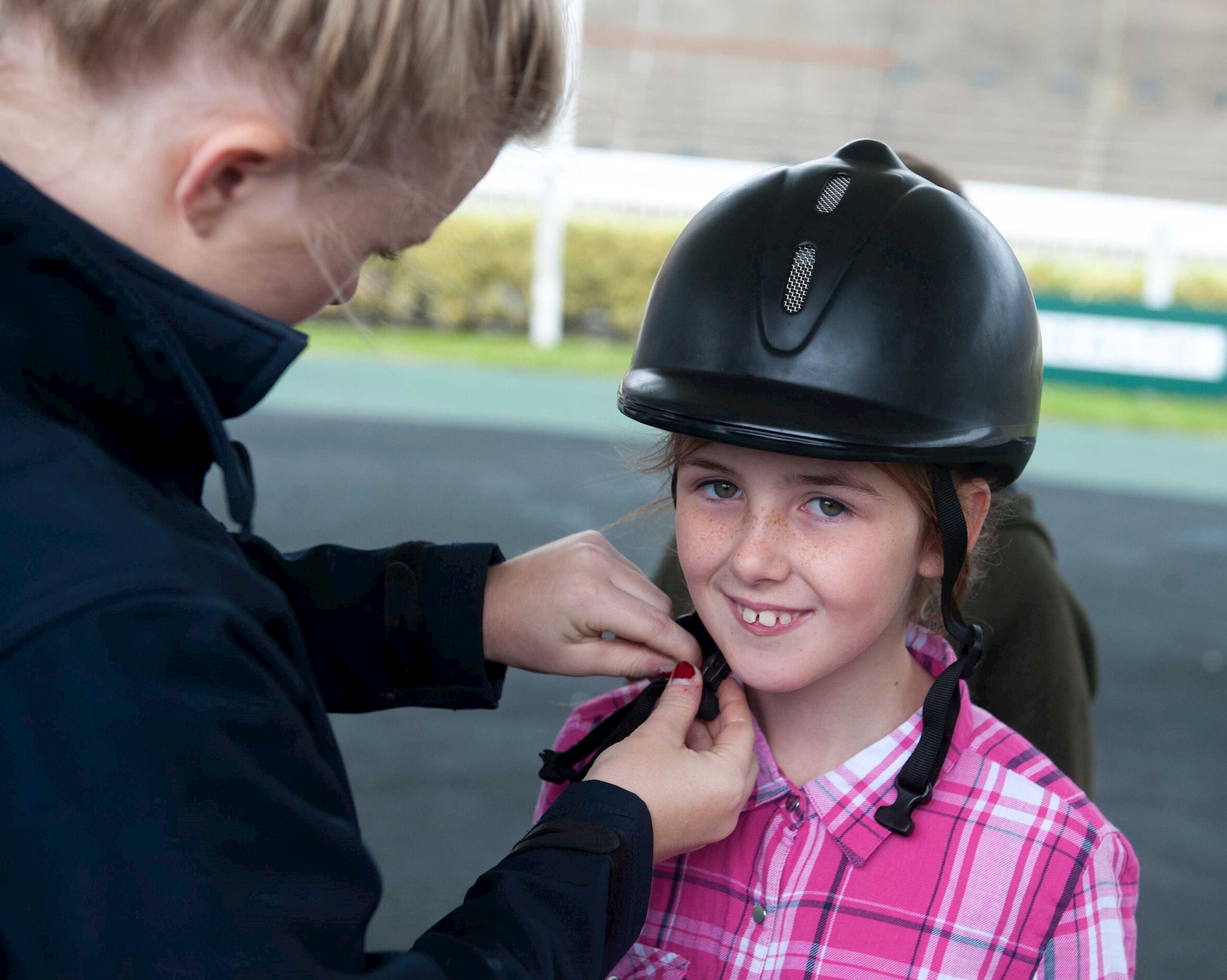 A school child taking part in a riding lesson hosted at Aintree Racecourse as party of the community programme