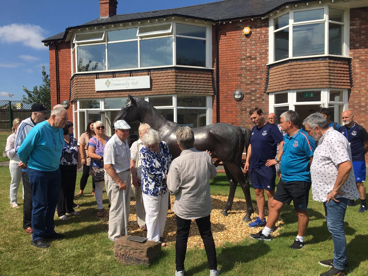 A group of people outside the Community Hub at Aintree Racecourse
