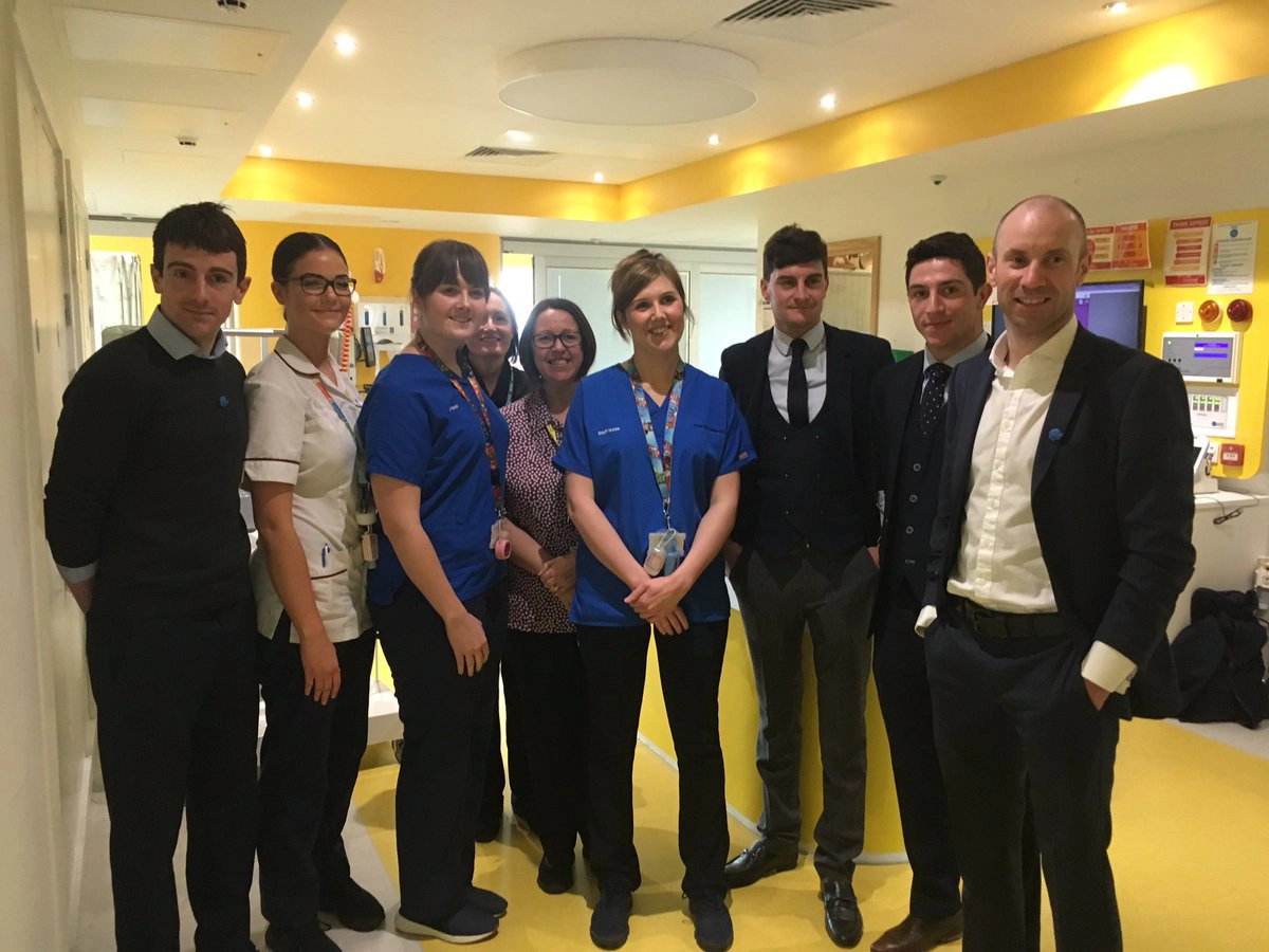 A group of jockeys and nurses pictured during a visit to Alder Hey Children